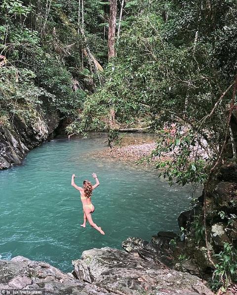 Swimmers in the clear freshwater pools below the falls at Currumbin Rock Pools