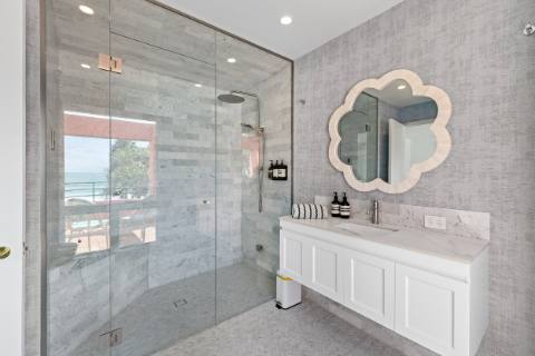 Marble ensuite with walk-in rain shower and scalloped mirror