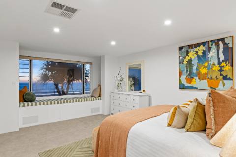 Master bedroom with king bed and an ocean-view window