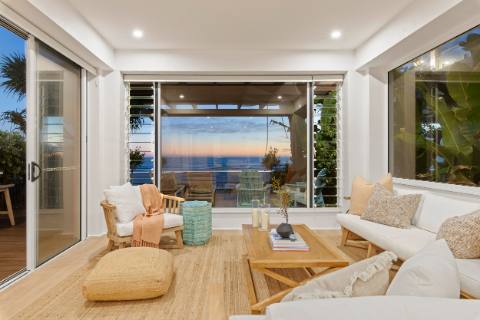 Living room with sliding doors opening to the beachfront balcony