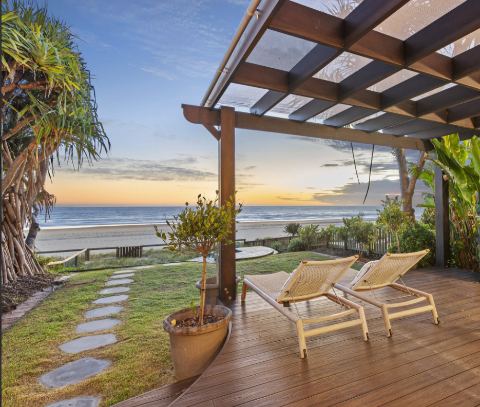Sun loungers under the pergola on the beachfront terrace